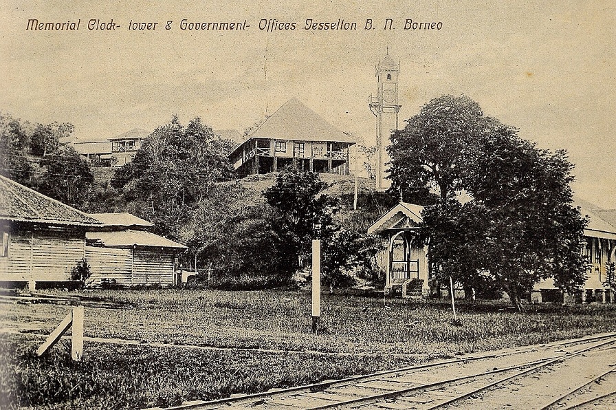 Atkinson Memorial Clock Tower and government offices in British North Borneo in 1910. Note the railway track.