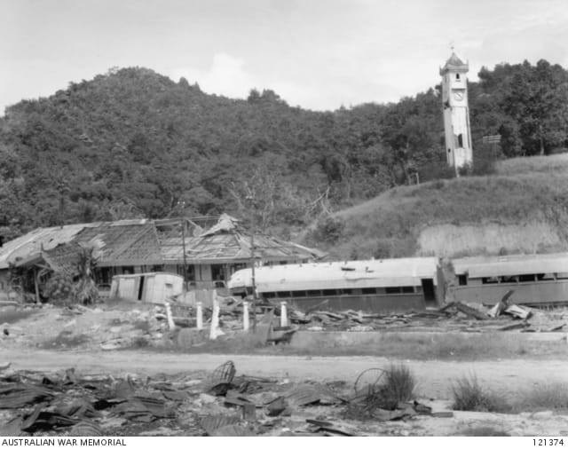 Note a slightly damaged Atkinson Memorial Clock Tower after WWII bombings. Seen visibly damaged are train carriages and Railway Office at foreground. 