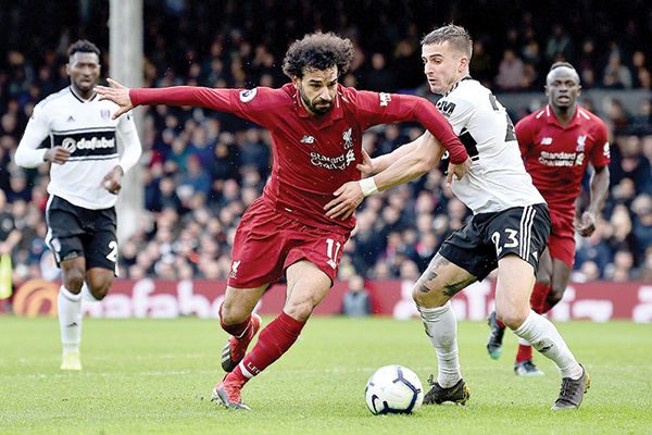 Liverpool  survive Fulham  scare to go top 