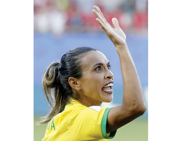 Record-breaker Marta  fires Brazil into last 16