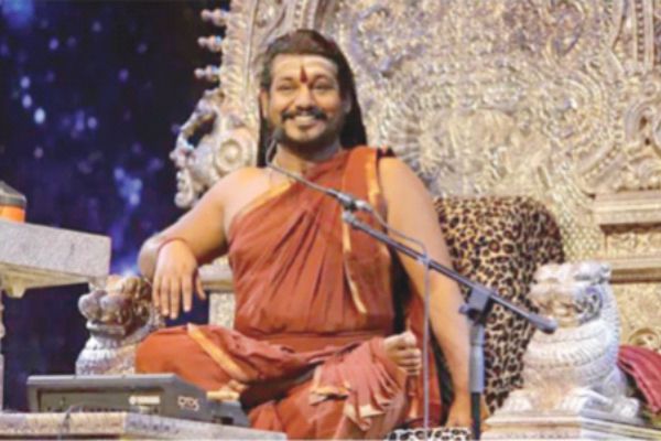 Wanted Indian guru resurfaces to announce new cosmic country