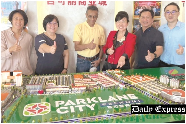 Susan (third right) and Vanessa (left) show Rohan  and his team the layout of Parklane City.