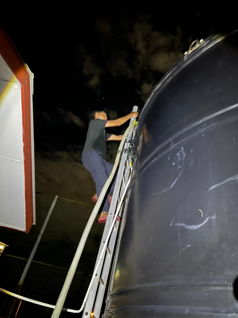A technician with the agency checks on the level of water inside the balancing tanks for Taman Kinarut Selatan.