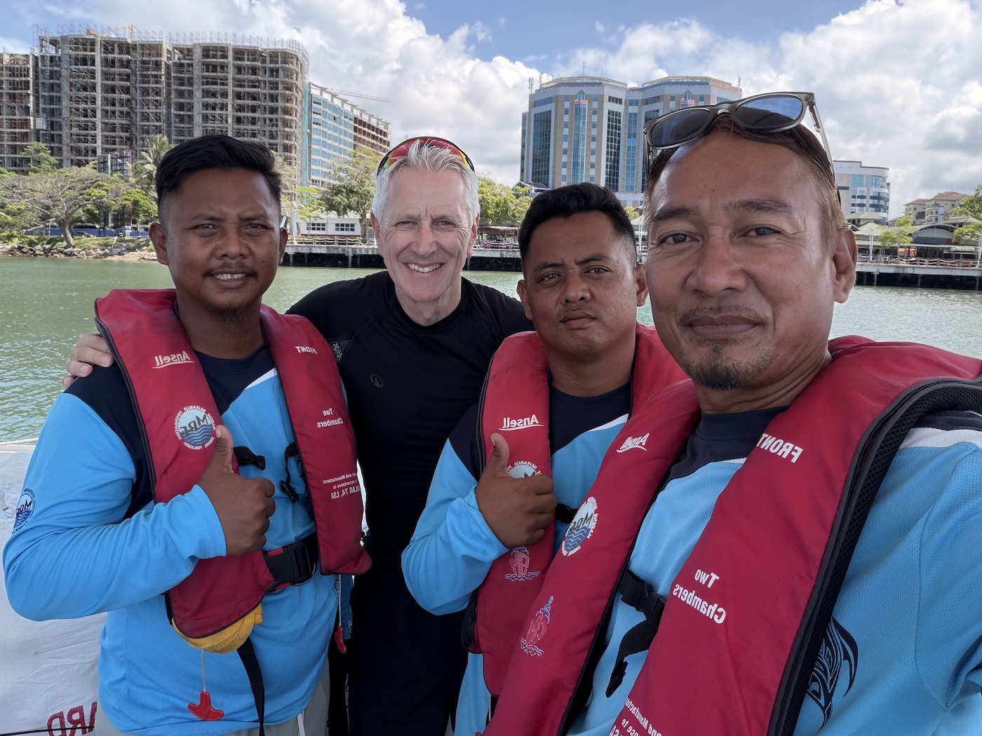 Binch (second left) in a group photo with the crew following a morning’s haul at sea. The moment captures the close bond and mutual respect between the MRF team and the photographer.